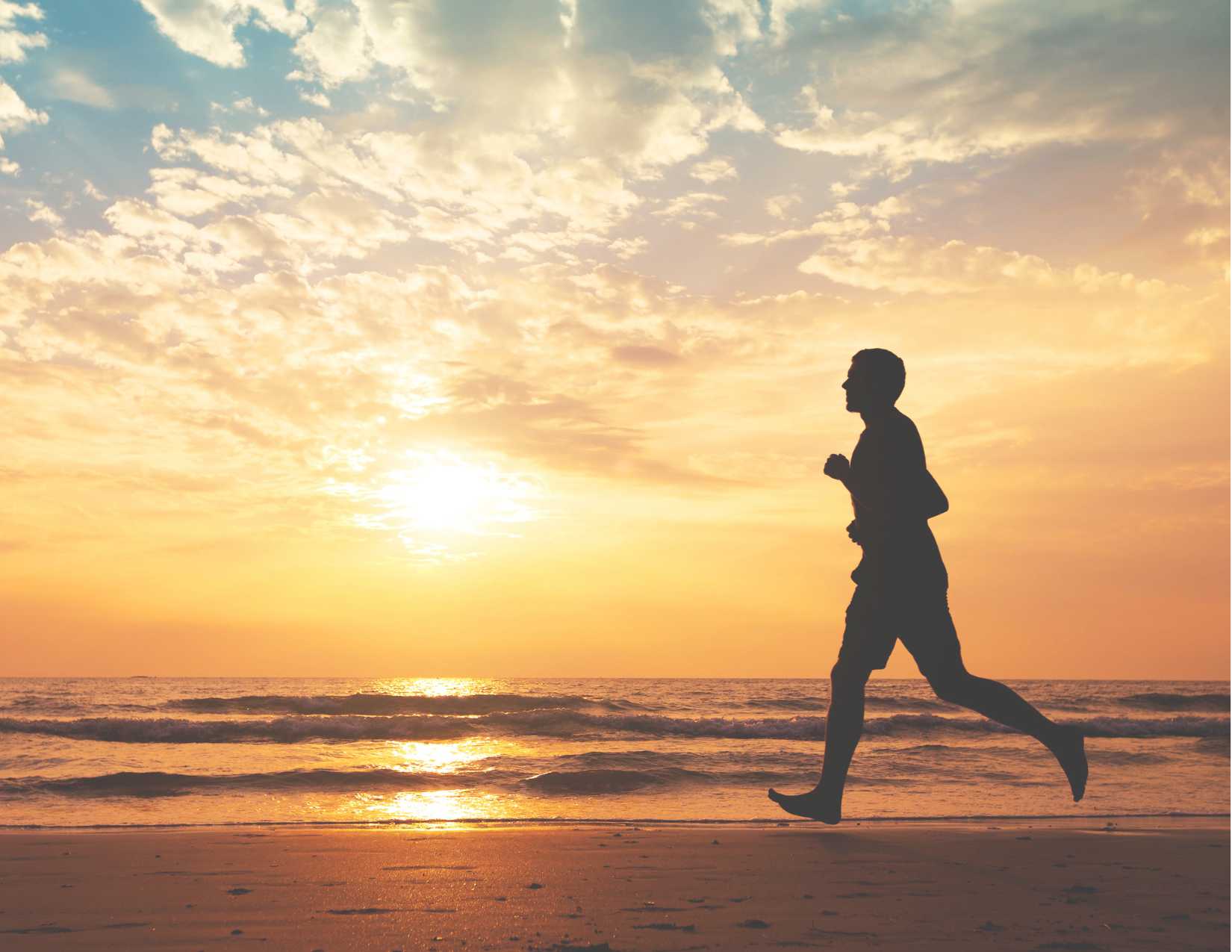 Person runs alongside beach 